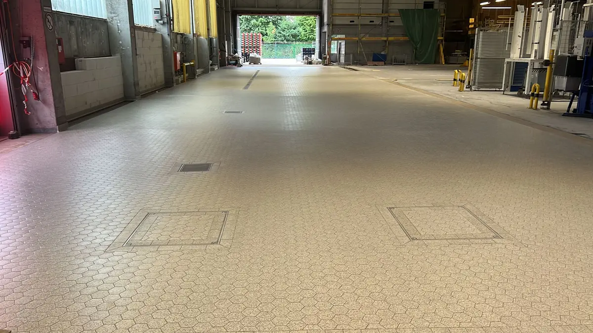 Pavimento industriale piastrellato dotato di canali di drenaggio, scarichi a pavimento e botole di ispezione